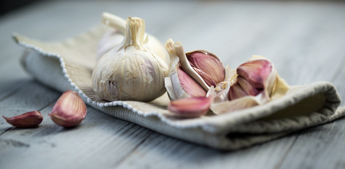Organic garlic on wooden background